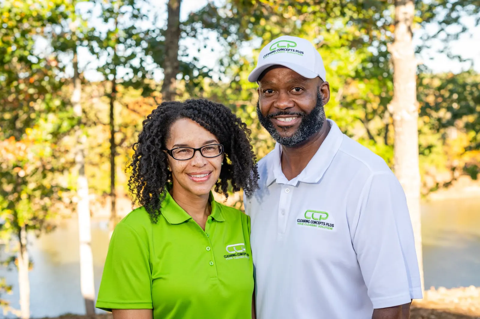 Owners Derrick and Shemelia Ervin smiling outdoors in Cleaning Concepts Plus shirts